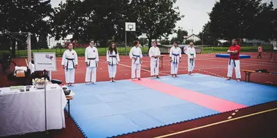 Gruppe steht in Reihe auf der Kampffläche im Freien