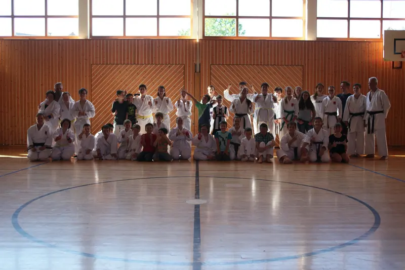 Große Gruppe im Karategi posiert für ein Gruppenfoto