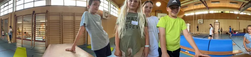 Zwei Kinder stehen nebeneinander in der Turnhalle