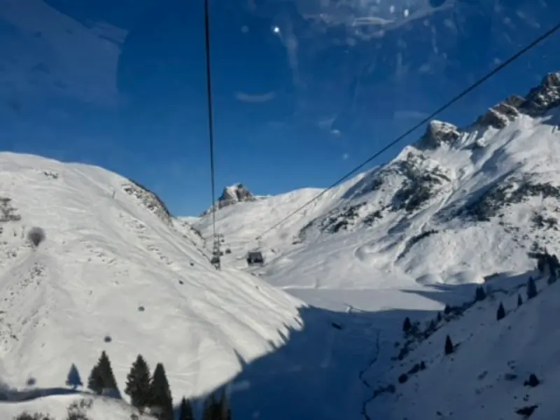 Blick aus einer Gondel auf verschneite Berge