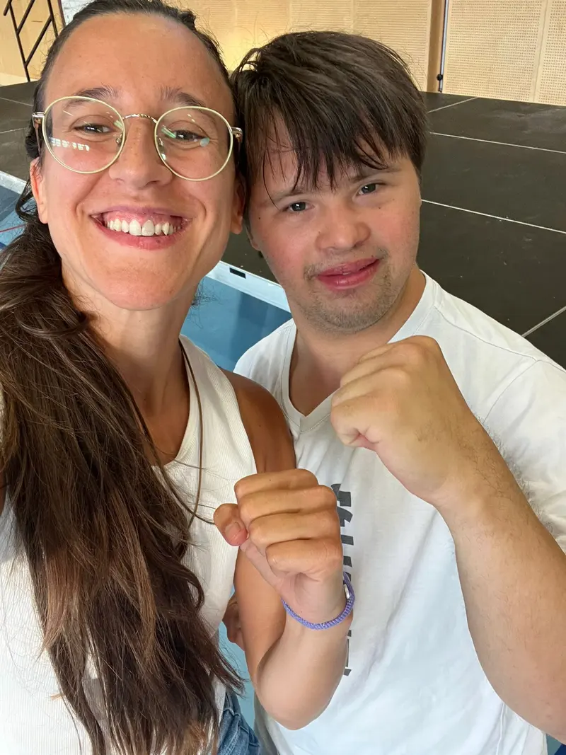 Zwei Personen posieren für Selfie, eine mit erhobener Faust